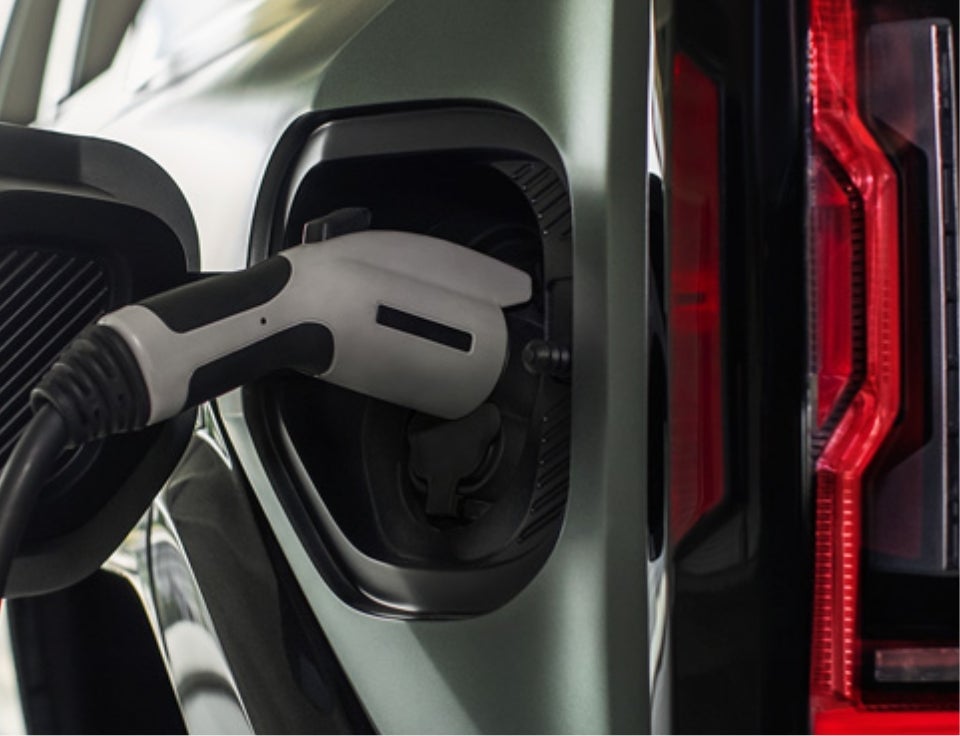Close up of charging port with charger plugged in on a GMC Hummer EV SUV - Ramsey GMC in chestertown MD